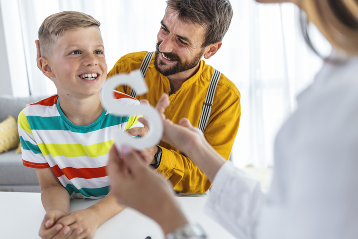Speech therapist works with a young boy